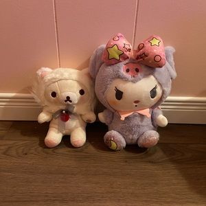 2 sanrio plushies, kuromi and rilakkuma